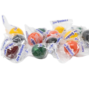 Assorted colorful jaw breakers in clear packaging on a white background